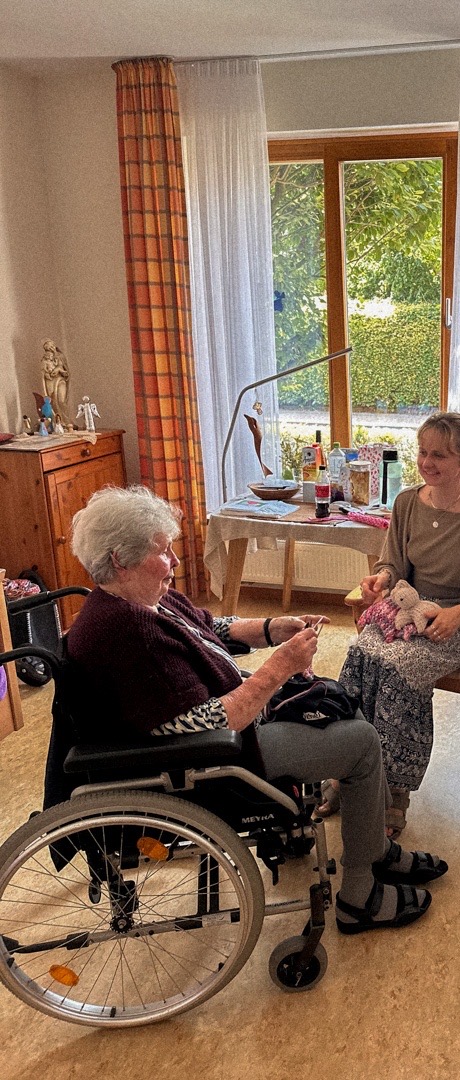 Margret and a companion knitting together by the window