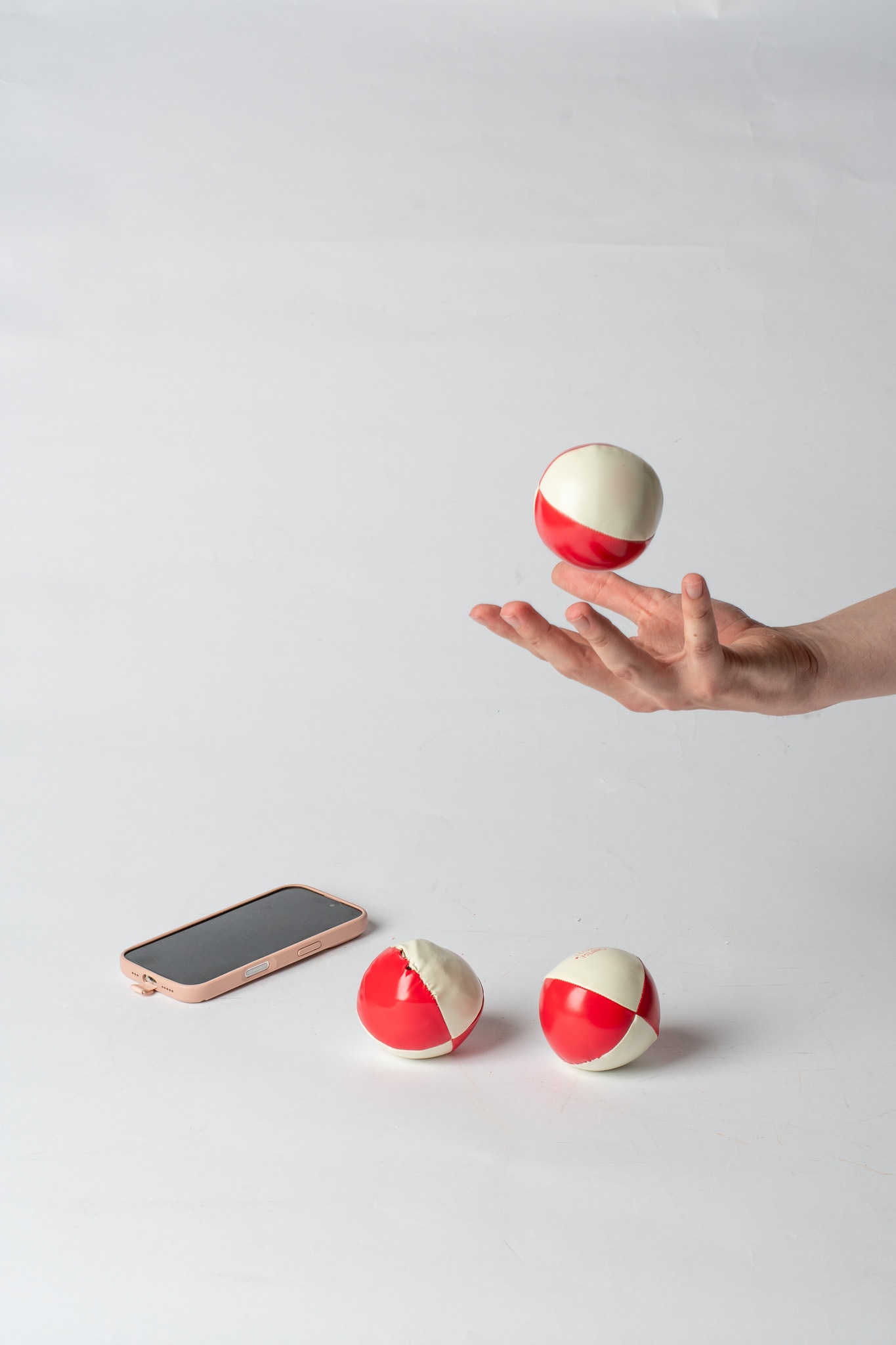 A juggling ball tossed above an open hand